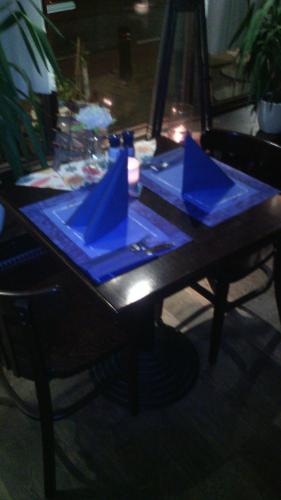 a table with blue napkins on top of it at Schuttershof Heerlen - Adults Only in Heerlen