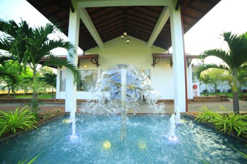 a water fountain in front of a building at Ruins Chaaya Hotel in Polonnaruwa