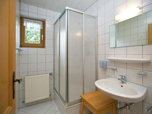 a white bathroom with a sink and a shower at Plush Apartment in Altenmarkt im Pongau near Ski Area in Altenmarkt im Pongau