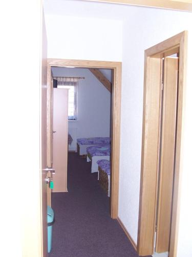 a hallway with a row of beds in a room at Penzion Chanos in Stříbro