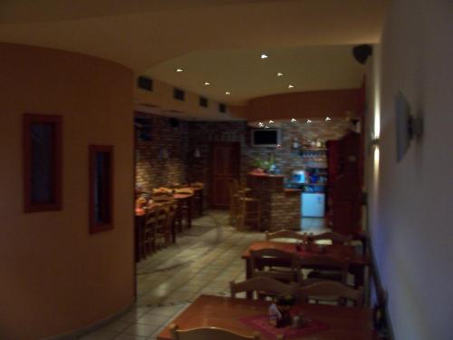 a room with tables and chairs in a restaurant at Penzion Chanos in Stříbro