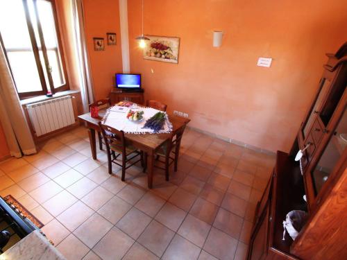 a dining room with a table and a television at Apartment in Montalto near Lake and Pool in Montalto di Castro