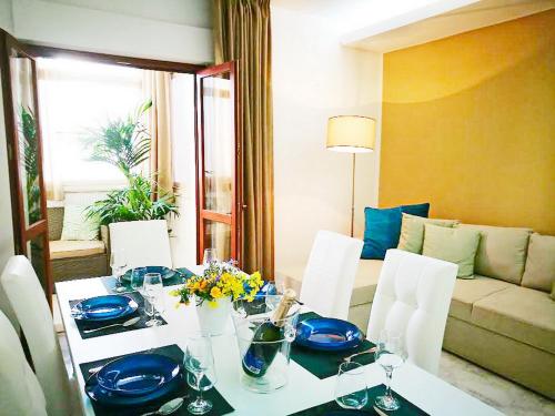 a dining room with a table with blue dishes on it at Acquamarina Apartment with Terrace in Marsala