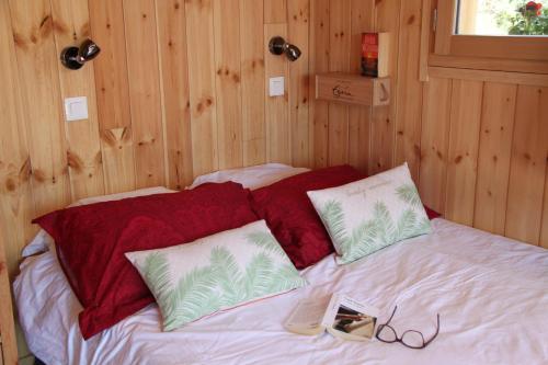 a bed in a room with wooden walls at Clos Shambhala-Chalet d'hôtes in Saint-Jean-Saint-Nicolas