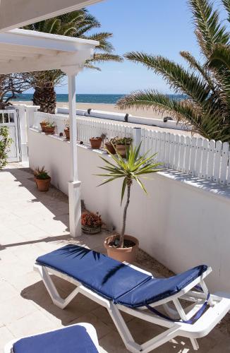 avisorvisor shot of a patio with a chair and a palm tree at Villa Mela in Playa Honda