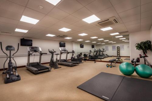 a gym with treadmills and exercise equipment in a room at Carlton Hotel Dublin Airport in Cloghran
