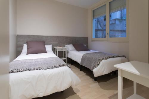 Postel nebo postele na pokoji v ubytování Bravissimo Cort Reial-3A