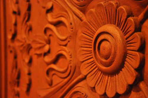 a wooden door with a flower design on it at Hotel Noah in Ginowan