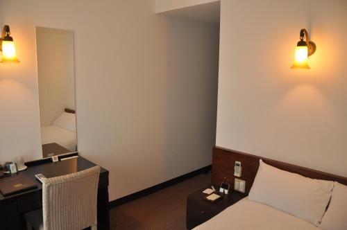 Un pat sau paturi într-o cameră la Hotel Noah