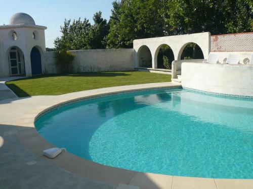 a large swimming pool in a yard with a patio at Holiday home with private pool in Villedaigne