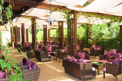 a patio with purple furniture and plants at Gardenia Park Hotel in Bansko