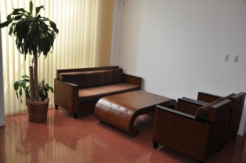 a living room with a couch and a chair at Hotel Noah in Ginowan