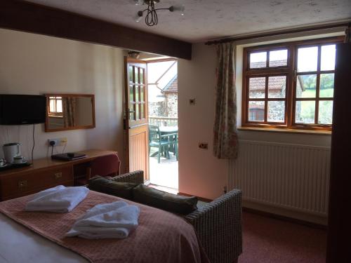 a bedroom with a bed with two towels on it at Sid Valley Country House Hotel in Sidmouth