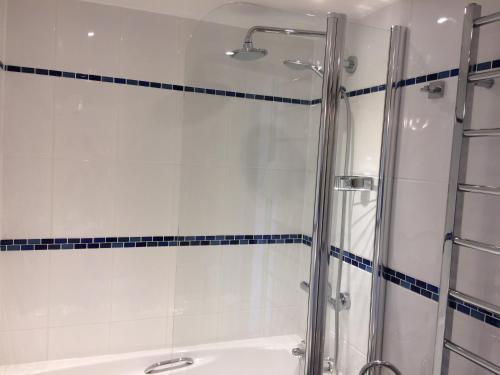 a bathroom with a shower and a bath tub at Sid Valley Country House Hotel in Sidmouth