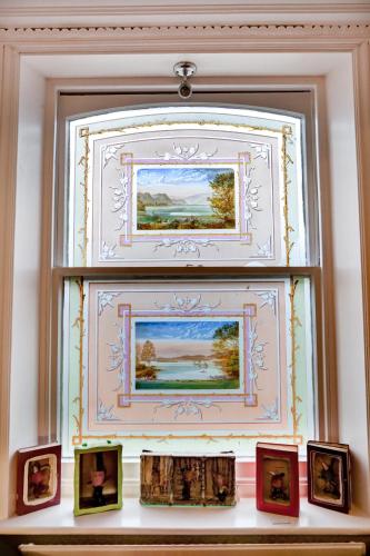 a window in a room with pictures on a shelf at The Claremont in Brighton & Hove