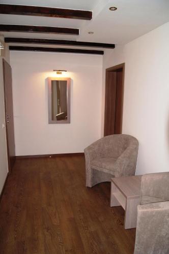 a living room with a couch and a table at Pensiunea JOJO in Băile Herculane