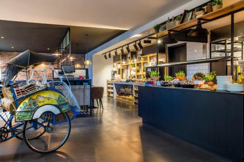 a bike parked next to a counter in a restaurant at Park Inn By Radisson Brussels Airport in Diegem
