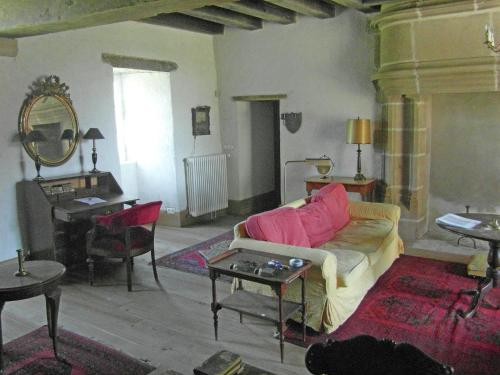 a living room with a couch and a piano at Ch teau in Auvergne with river and terrace in Le Veurdre