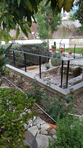 a garden with a table and a fence at Vasilion Agrotourism in Polis Chrysochous