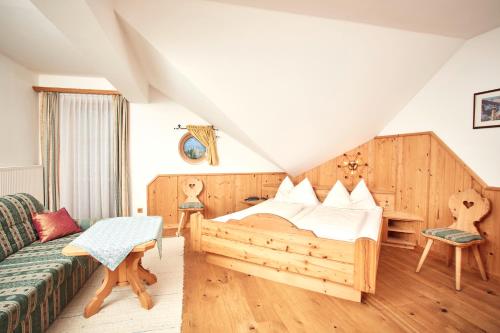 a bedroom with a bed and a couch at Bloberger Hof in Salzburg