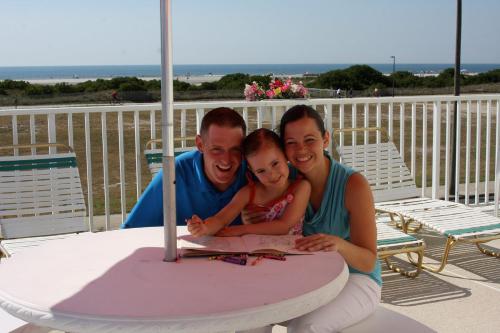a man and woman sitting at a table with a little girl at Lotus Inn in Wildwood Crest