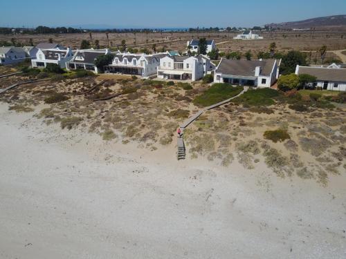 a group of houses on top of a beach at 3 Dolphins in Britannia Bay