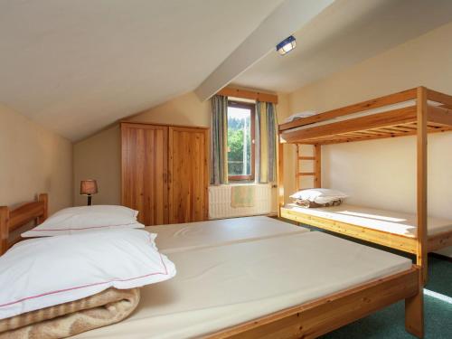 a bedroom with two bunk beds and a window at Spacious holiday home with roofed terrace in La Gleize