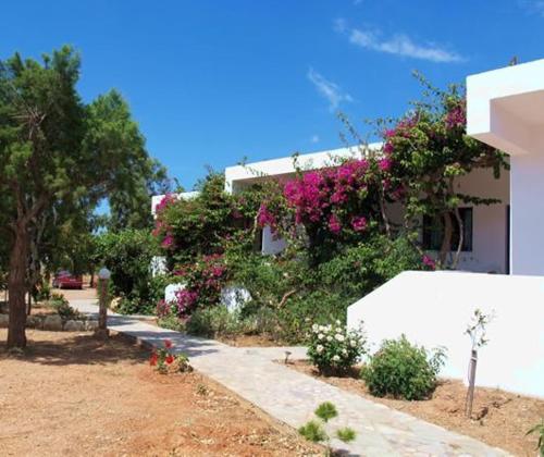 a house with flowers on the side of it at Fragokastello Star in Frangokastello