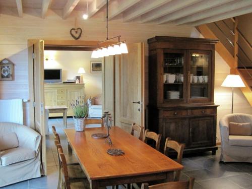 a dining room with a wooden table and chairs at Fort like Holiday Home in Sart Bertrix a drive away from Luxembourg in Sart