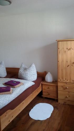 a bedroom with two beds and a dresser at Ferienhaus Mack in Wernigerode