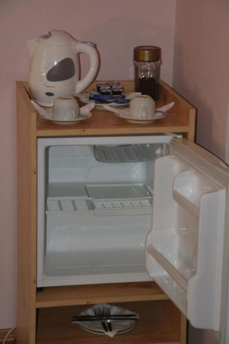 an open refrigerator with a tea pot on top of it at Chebsky dvur - Egerlander Hof in Karlovy Vary