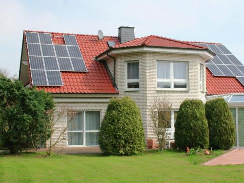 a house with solar panels on the roof at Apartment in Nieheim on the edge of the forest in Sandebeck