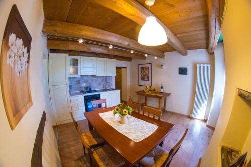 a kitchen and dining room with a table and chairs at Il Borgo Dei Celti in Fiumalbo