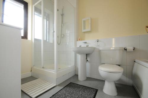 a bathroom with a toilet and a sink and a shower at The Rathmore in Cambridge