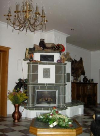 a living room with a fireplace and a chandelier at Bengel's Hotel zur Krone in Mülheim-Kärlich