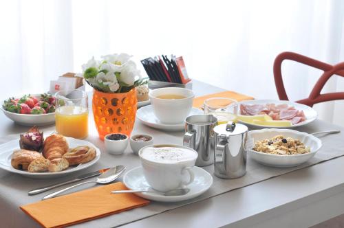 a table with breakfast foods and coffee on it at Canto degli Aranci in Florence