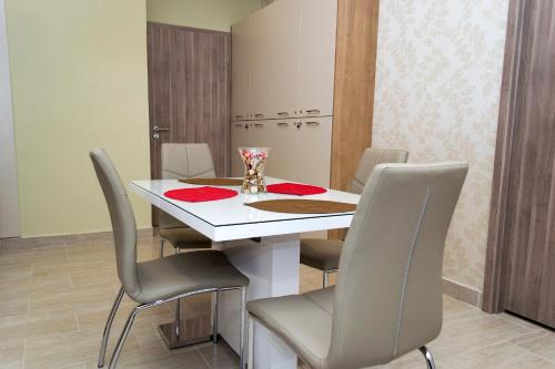 a dining room with a white table and chairs at Ditta Panzio in Debrecen