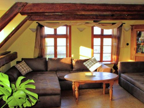 a living room with a couch and a table at Apartment in farm on the edge of the L neburg in Langlingen