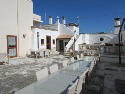 a patio with a table and chairs in front of a building at Masseria Sant'Anna in Bari