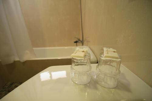 two glass jars sitting on top of a bathroom sink at Hotel la Palmera & Spa in Lloret de Mar