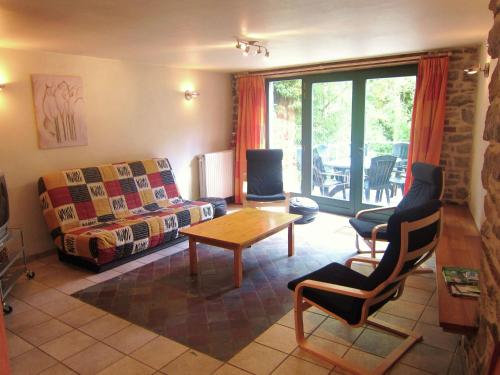 a living room with a couch and a table at Alpine Getaway in Neustift in Treignes