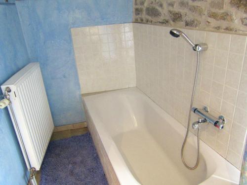 a bathroom with a bath tub with a shower at Alpine Getaway in Neustift in Treignes