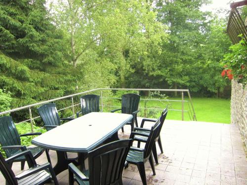 a table and chairs sitting on a patio at Alpine Getaway in Neustift in Treignes