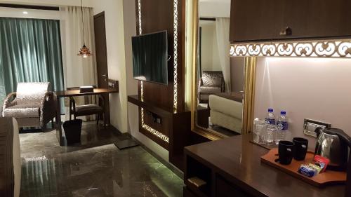 a hotel room with a large mirror and a living room at Hotel Peninsula Redpine in Mumbai