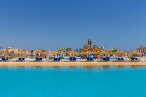 a group of chairs and umbrellas on a beach at Pickalbatros Aqua Park Sharm El Sheikh in Sharm El Sheikh