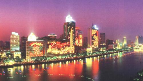 a city lit up at night with a river at Guangzhou Aiqun Hotel - Canton Fair Free Shuttle Bus during Canton Fair period in Guangzhou