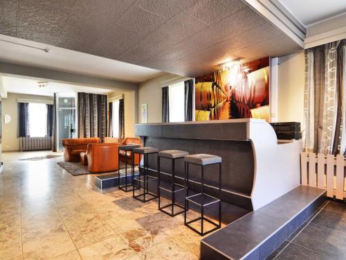 a lobby with a bar with stools at Comfortable holiday home in Marcourt with garden in Marcourt