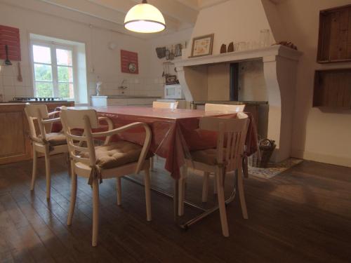 a kitchen with a table and chairs in a room at Spacious holiday home near the forest in Barricourt