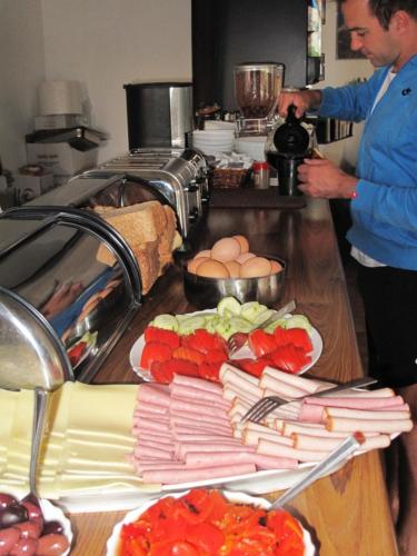 a man standing in a kitchen preparing food at Prasonisi Club in Kattavía