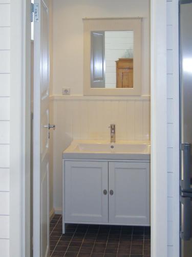 a bathroom with a white sink and a mirror at Villa Elisabeth Apartments in Pärnu